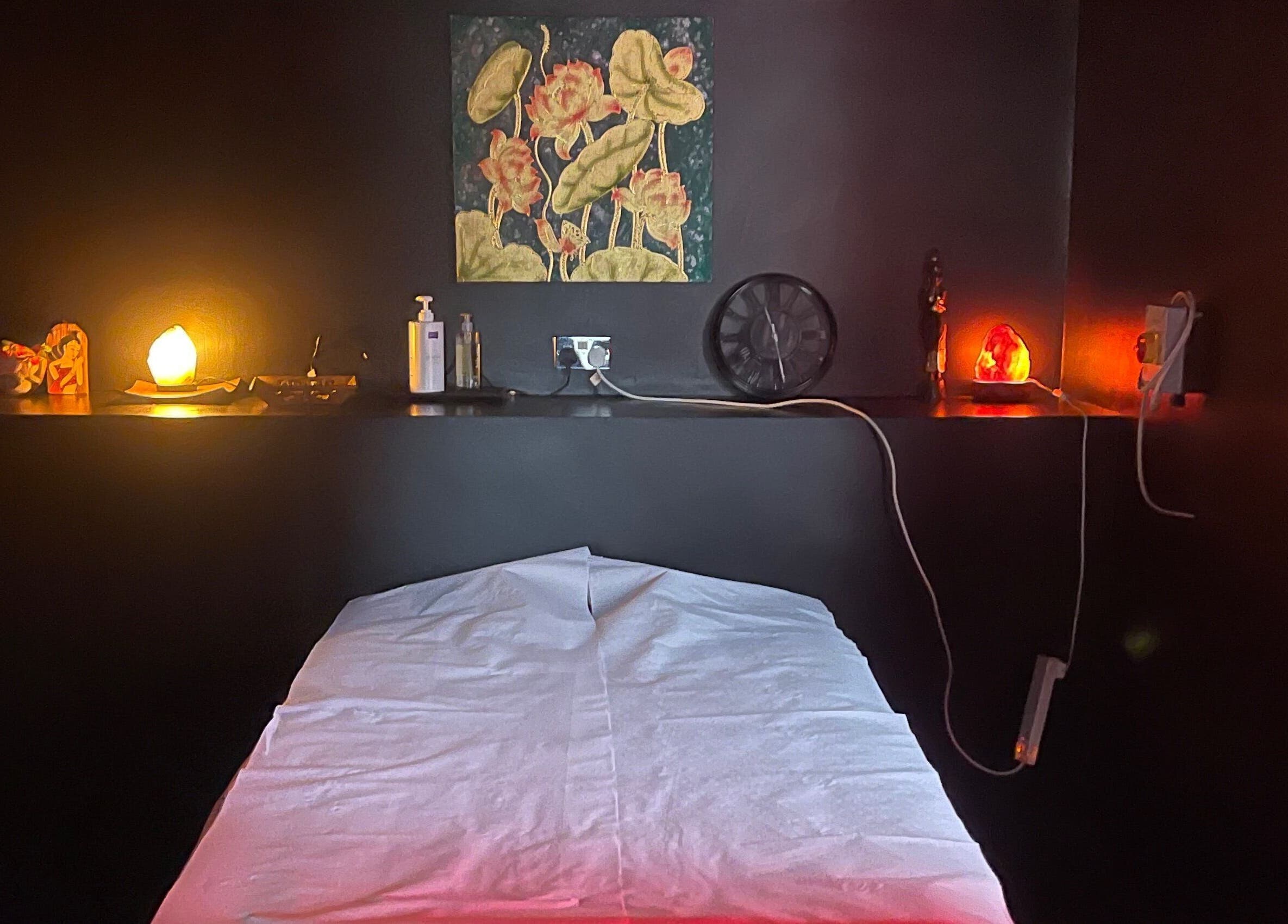 Relaxing massage room at Ann’s Thai Massage, March, England with warm lighting and soothing decor.