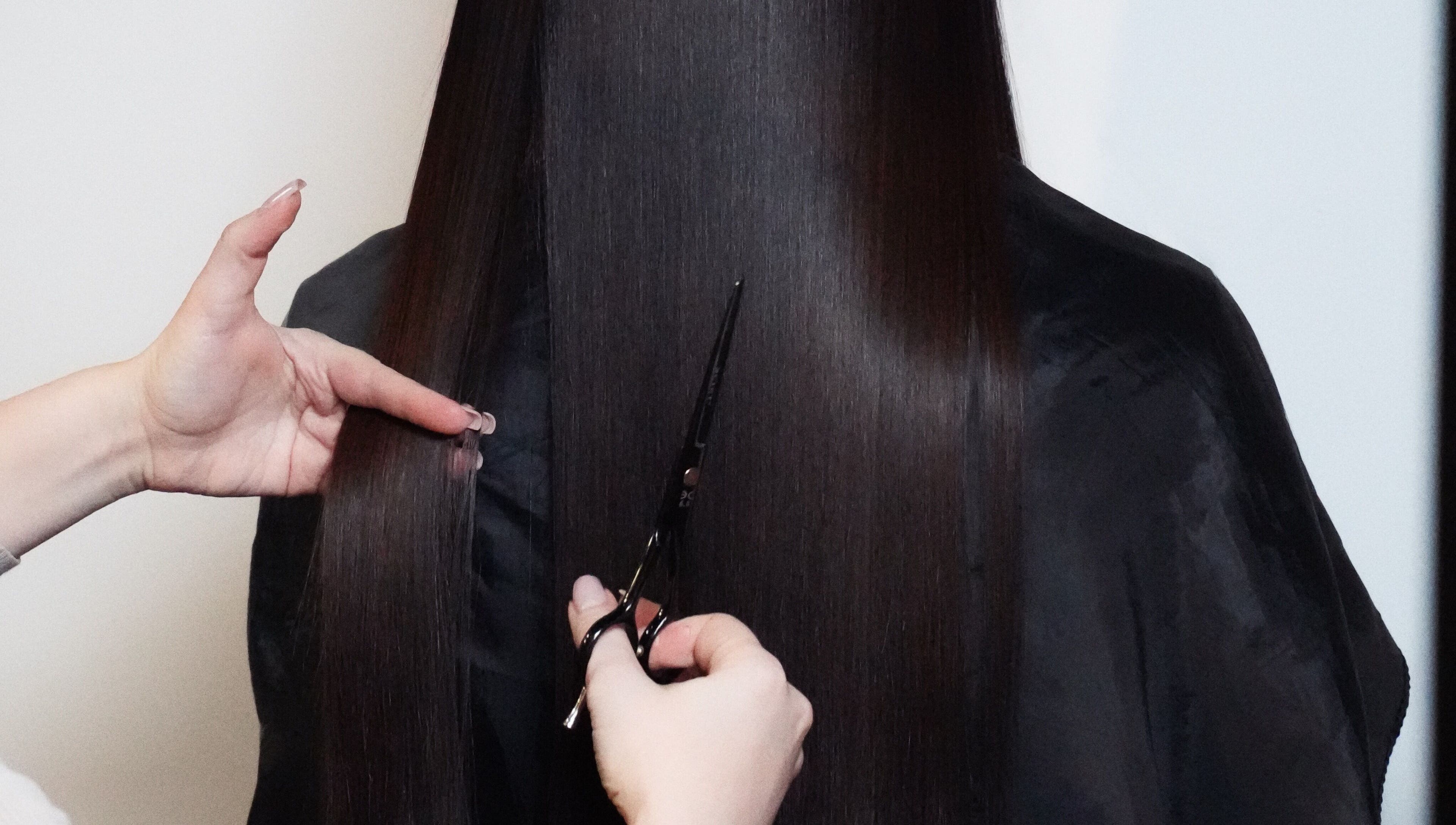 Professional haircut service at Glitz.Care.Bar, New Westminster, British Columbia, CA. Focus on sleek, long hair.