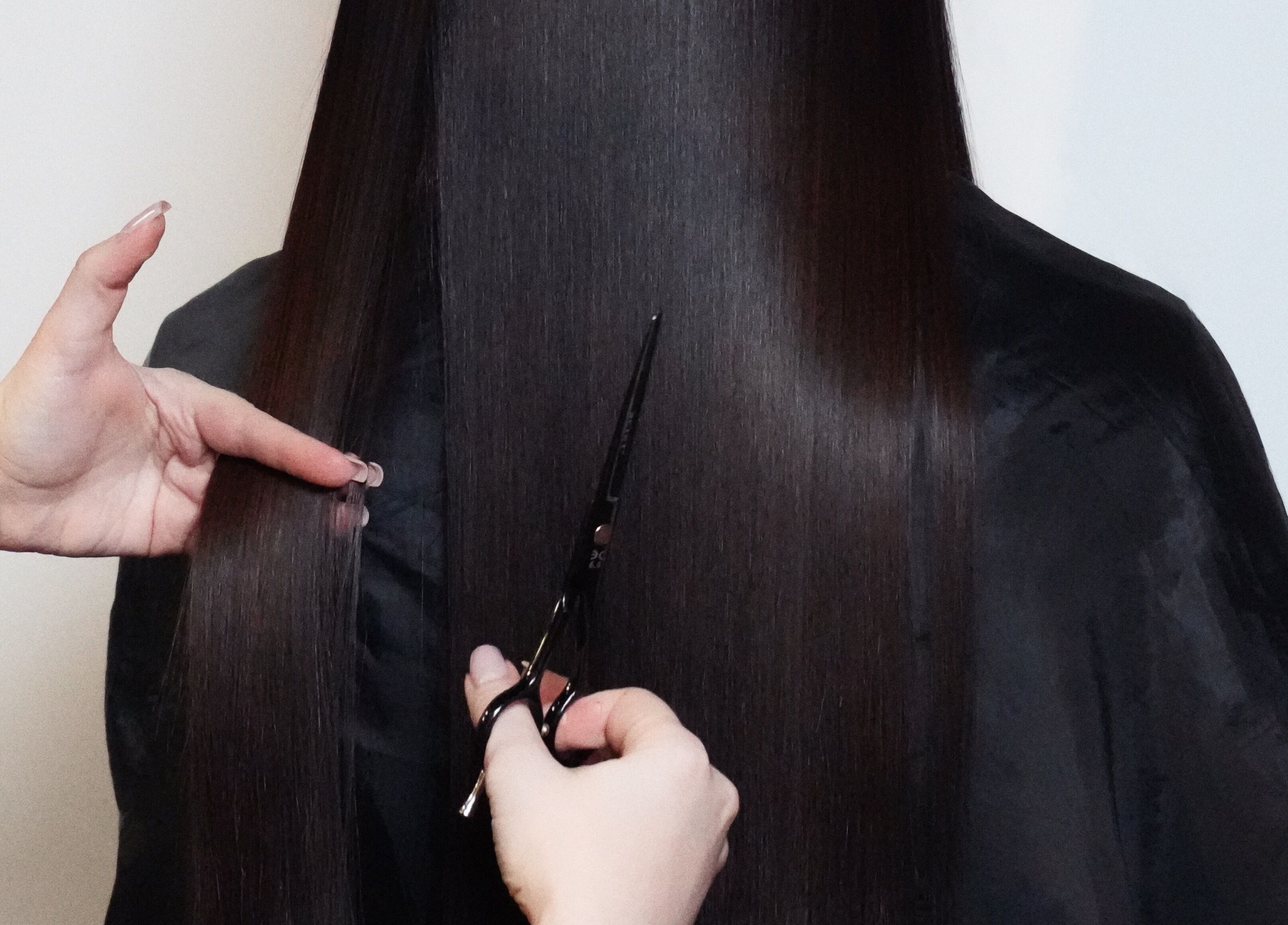 Professional haircut service at Glitz.Care.Bar, New Westminster, British Columbia, CA. Focus on sleek, long hair.