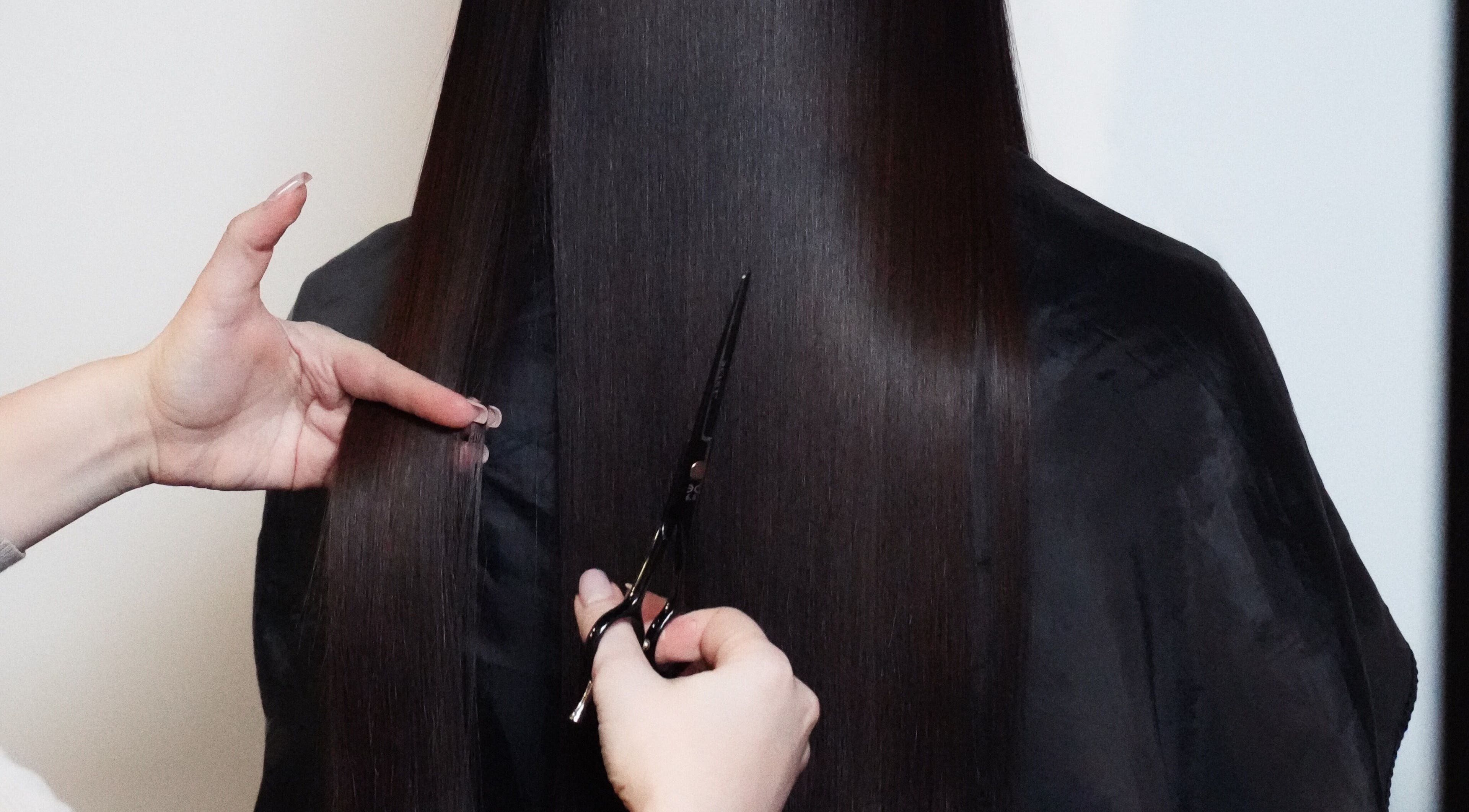 Professional haircut service at Glitz.Care.Bar, New Westminster, British Columbia, CA. Focus on sleek, long hair.