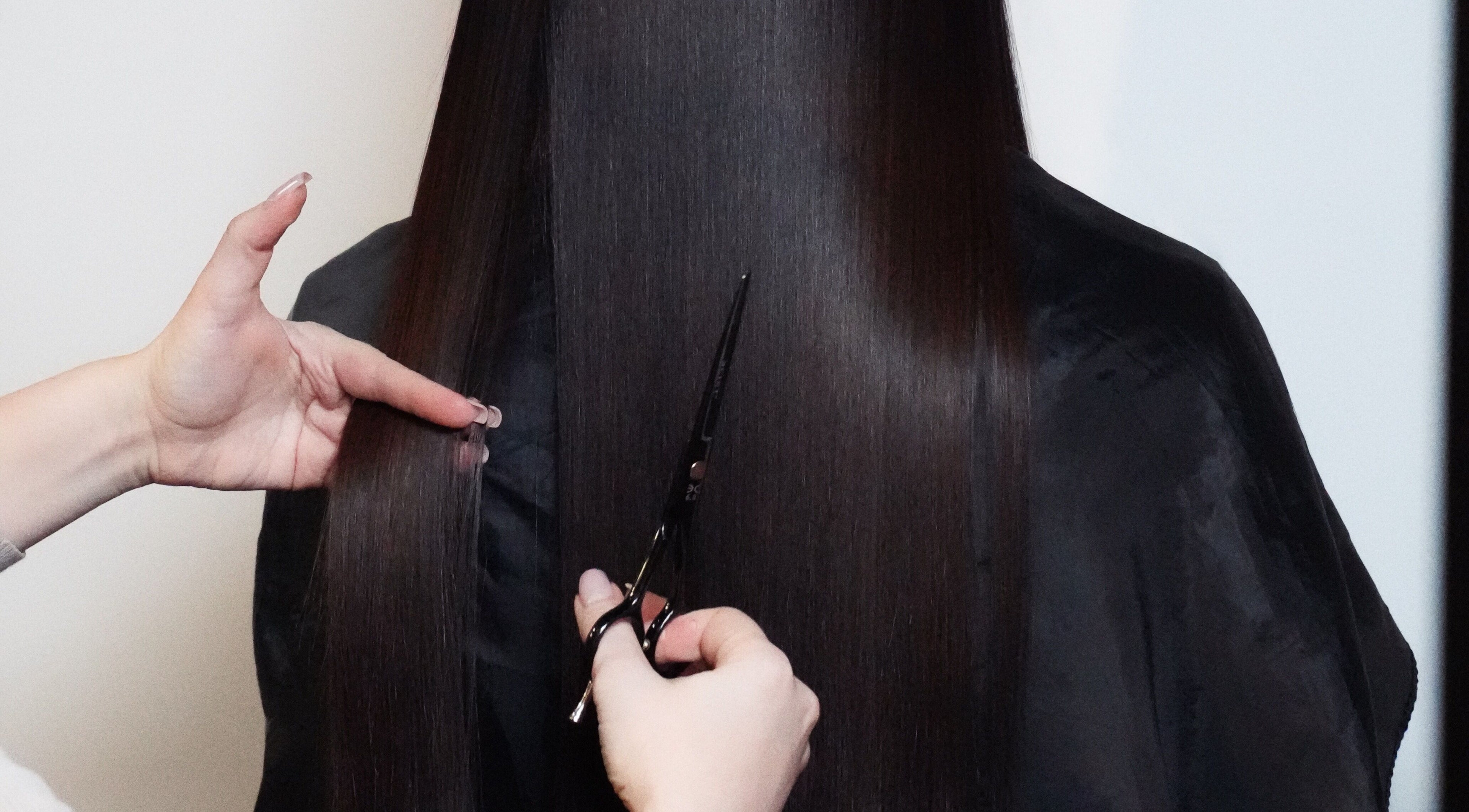 Professional haircut service at Glitz.Care.Bar, New Westminster, British Columbia, CA. Focus on sleek, long hair.