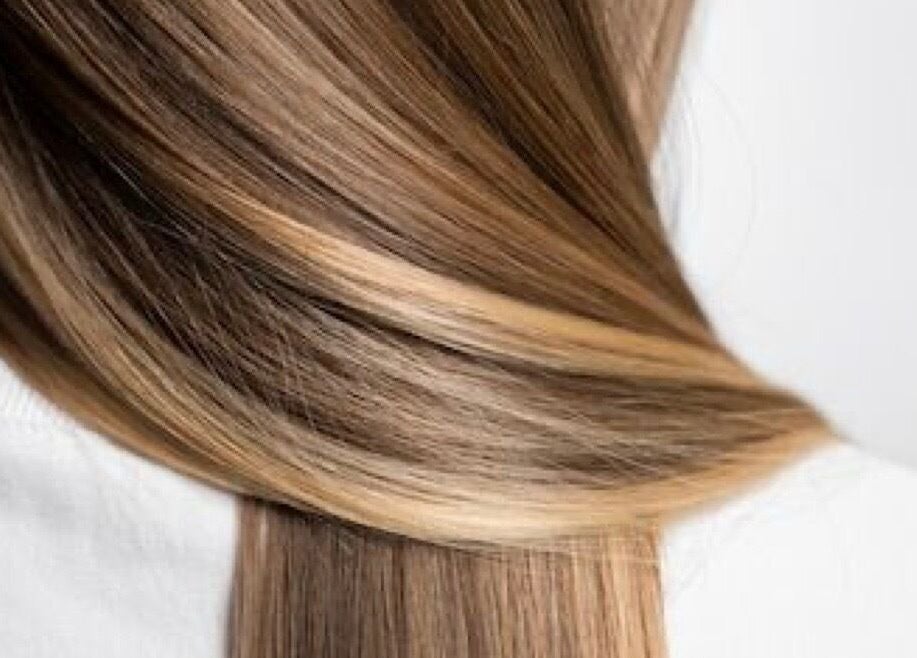 Smooth, shiny brown hair with highlights at Glitz.Care.Bar, New Westminster, British Columbia, CA.