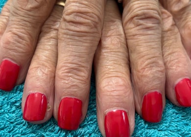 Elegant red manicure at JSSemiPermanantMakeUpByJodie, showcasing classic style in Sturry, England, GB.