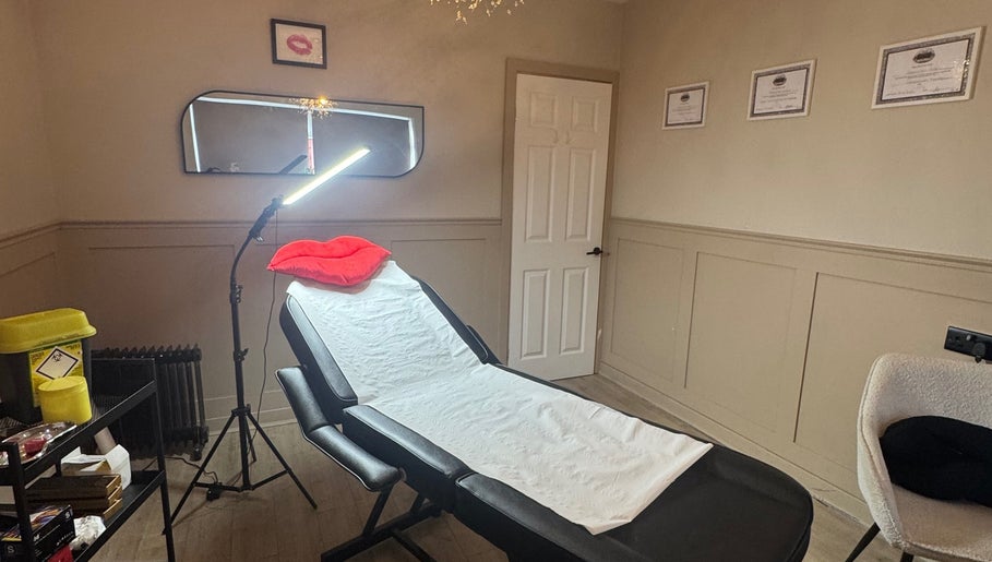 Relaxing treatment room at RA Aesthetics in Leyland, England, GB with a reclining chair and soft lighting.