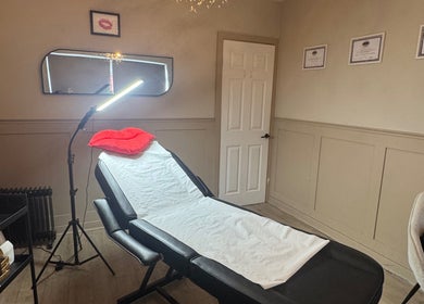 Relaxing treatment room at RA Aesthetics in Leyland, England, GB with a reclining chair and soft lighting.