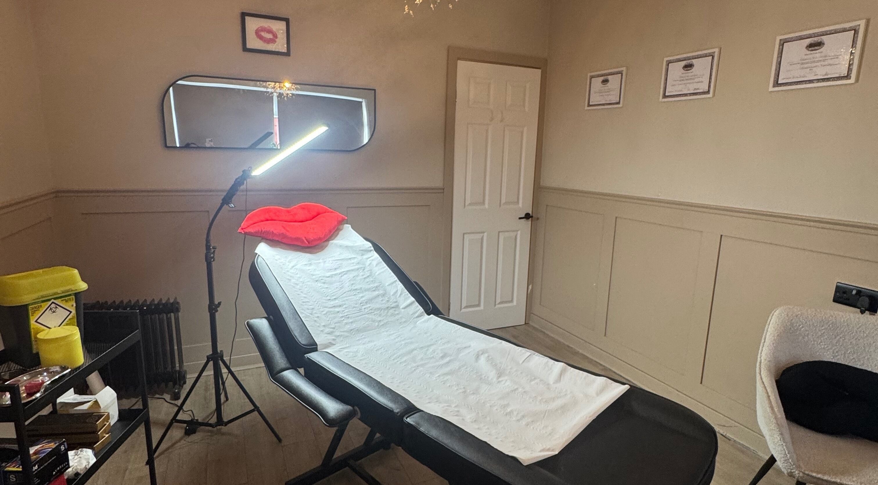 Relaxing treatment room at RA Aesthetics in Leyland, England, GB with a reclining chair and soft lighting.