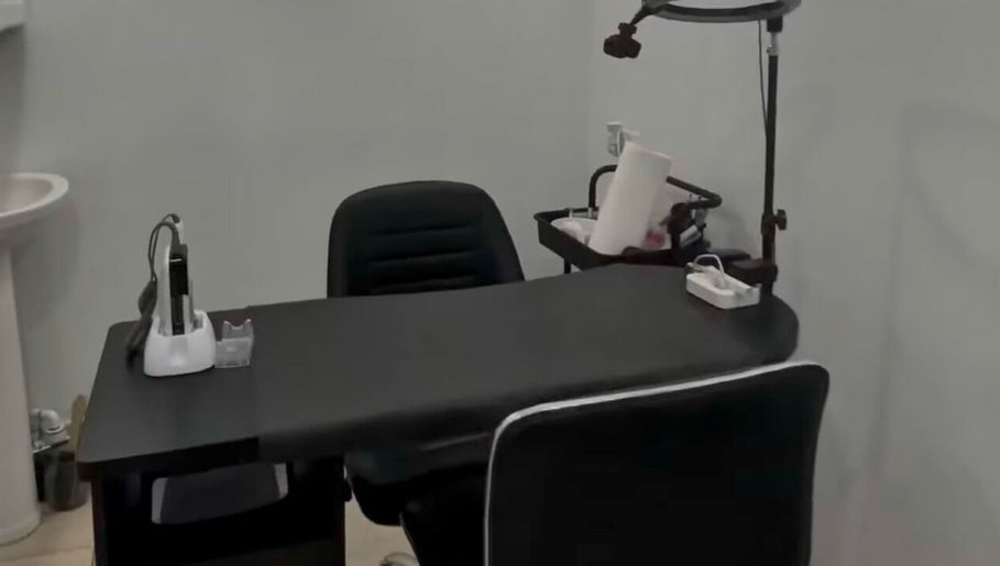Modern manicure station at 44 Sculpted Nails, Kingston, St. Andrew Parish, JM, with sleek black chair and table.