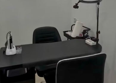 Modern manicure station at 44 Sculpted Nails, Kingston, St. Andrew Parish, JM, with sleek black chair and table.