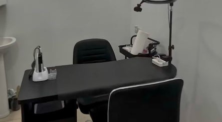 Modern manicure station at 44 Sculpted Nails, Kingston, St. Andrew Parish, JM, with sleek black chair and table.