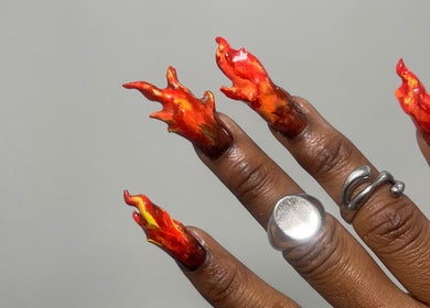 Bold flame nail art at 44 Sculpted Nails, Kingston, St. Andrew Parish, JM, featuring vibrant red and orange hues.