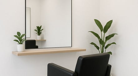 Modern salon corner with a sleek mirror and plant at 5ineStyles in Slough, England, GB.