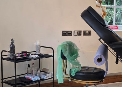 Tattoo studio setup at Charlotte Elizabeth Tattoos, Tarporley, England, GB featuring chair and tools.