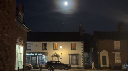 Charlotte Elizabeth Tattoos in Tarporley, England, GB, at night under a bright moonlight.