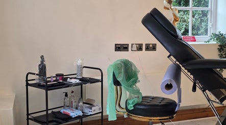 Tattoo station at Charlotte Elizabeth Tattoos, Chester, England, GB, featuring chair and tools.