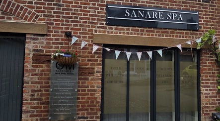The exterior of Charlotte Elizabeth Tattoos in Tarporley, England, GB, showcasing a rustic brick facade.