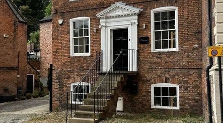 Elegant brick facade of Charlotte Elizabeth Tattoos in Chester, England, GB, showcasing the venue's classic architecture.