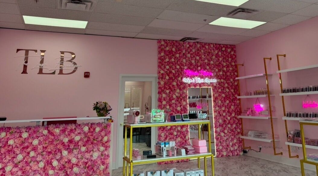 Chic interior of The Lash Boutique in Tukwila, Washington, US with pink floral decor and products on display.