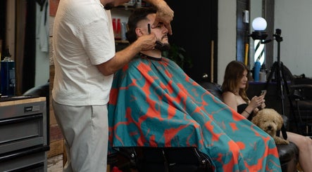 Barber crafting a stylish look at Motown Granby, Granby, Quebec, CA with a client in focus.
