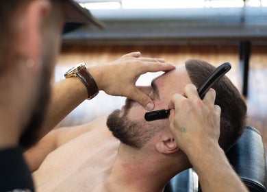 Close-up of a barber shaping a man's beard at Motown Granby in Granby, Quebec, CA.