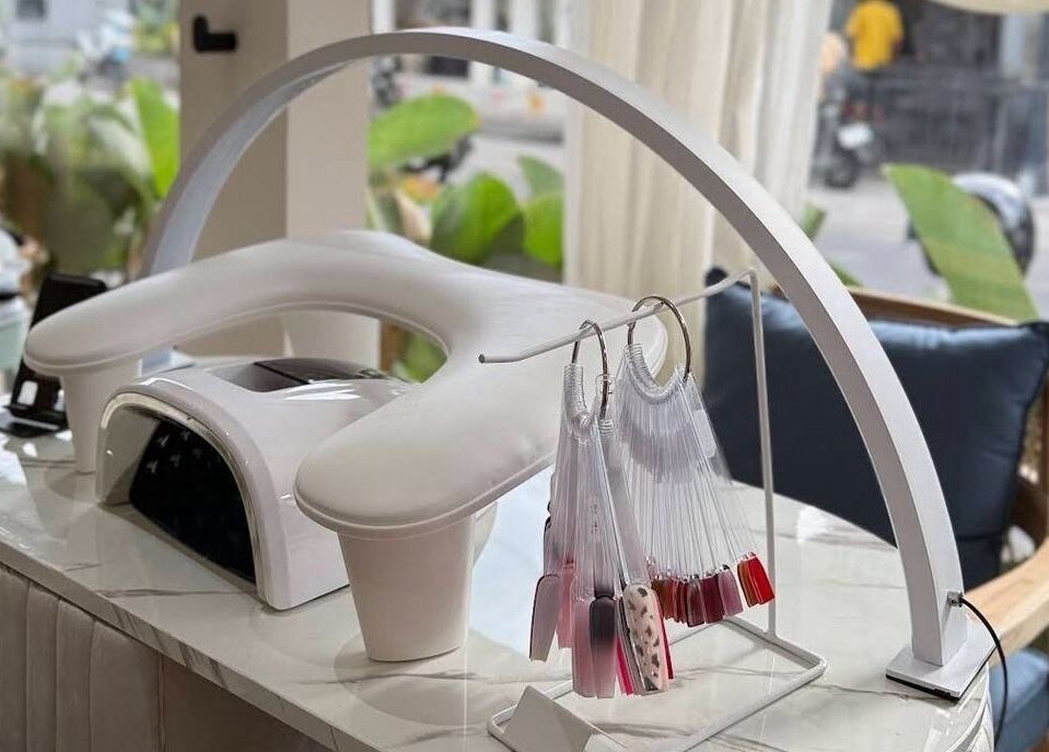 Nail polish display and UV lamp at Suka Kuku, Bali, Bali, ID. Inviting space for beauty treatments.