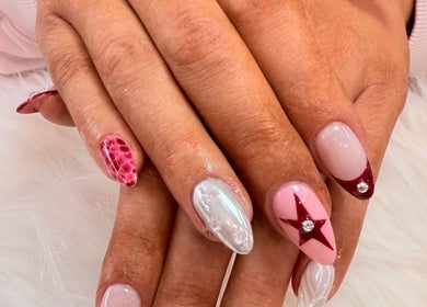 Stylish nail art design at Lotus Leaf Beauty Salon in Melbourne, Victoria, AU, featuring unique patterns and gems.
