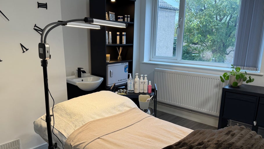 Relaxing treatment room at Unforgotten Skin, Winterbourne, England, GB, with calming decor and natural light.