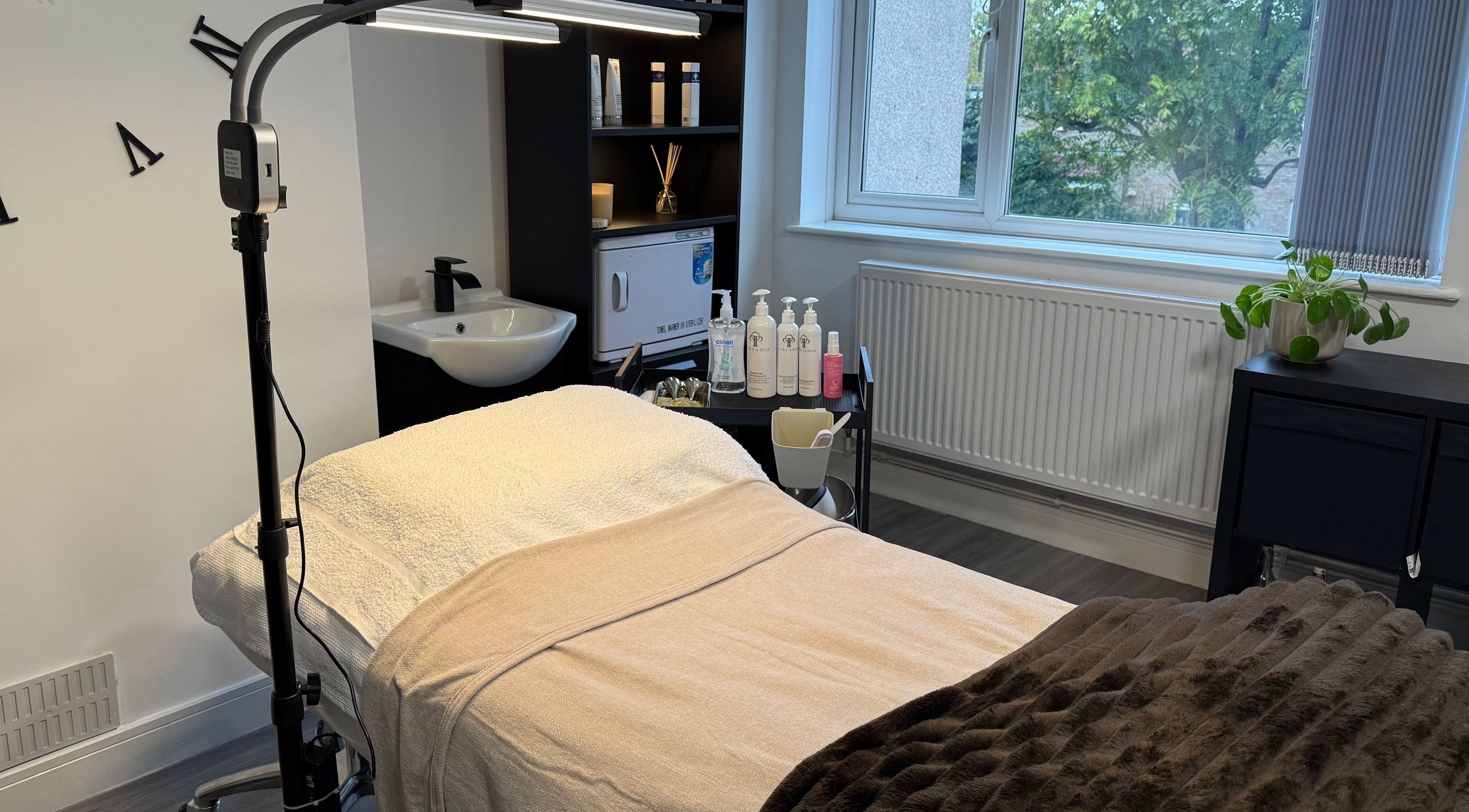 Luxurious treatment room at Unforgotten Skin, Winterbourne, England, GB, with cozy ambiance and professional products.