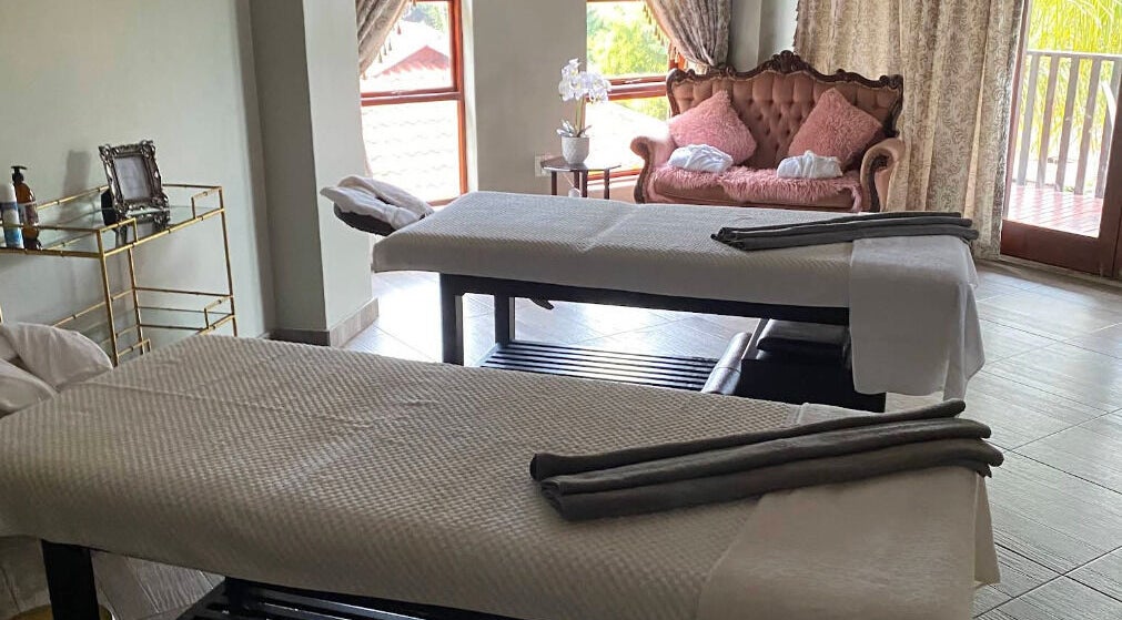 Luxurious treatment room at Rifumo Boutique Spa, Mbombela, Mpumalanga, ZA, featuring elegant decor and massage tables.