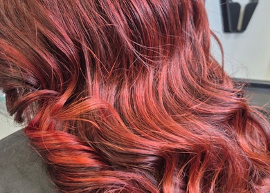 Red wavy hair styling at Ooh Hair in County Louth, County Louth, IE, showcasing vibrant color and shine.