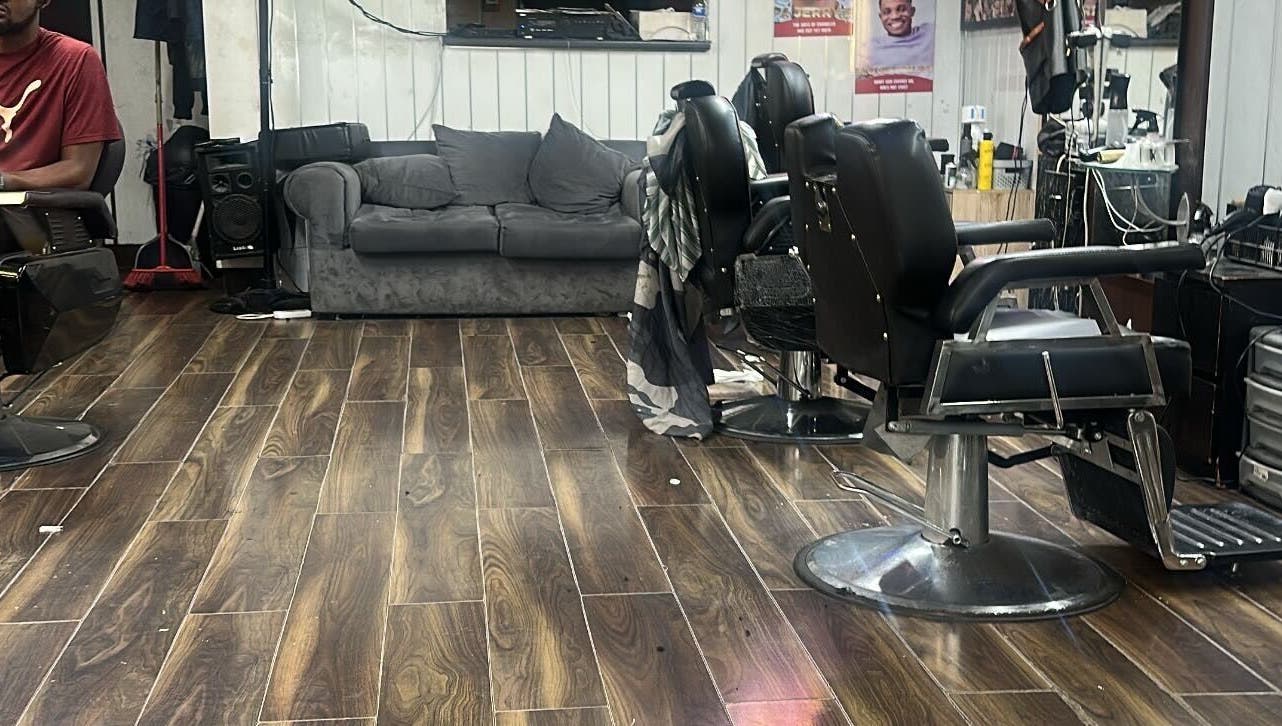 Cozy interior of K.Klippz salon with barber chairs and couch in Manchester, England, GB.