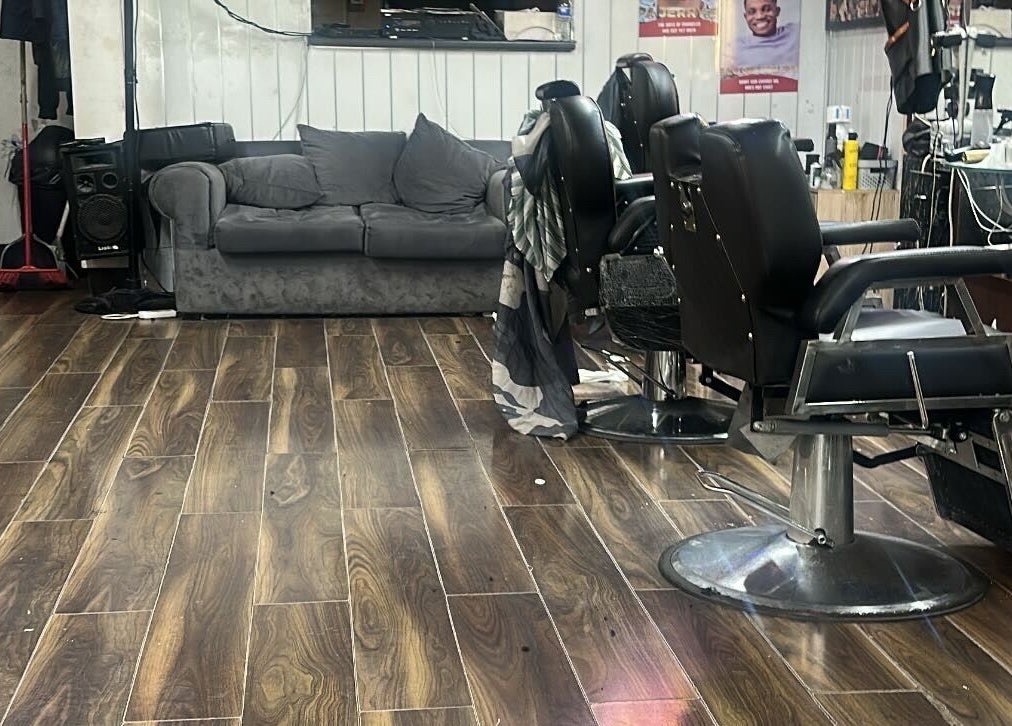 Cozy interior of K.Klippz salon with barber chairs and couch in Manchester, England, GB.