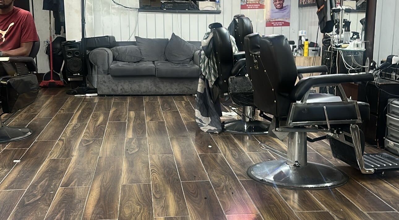 Cozy interior of K.Klippz salon with barber chairs and couch in Manchester, England, GB.