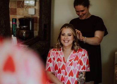Smiling client in heart-patterned robe at The Healing Head Spa by Amiee Lauren Hairdressing, Leighton Buzzard, England.