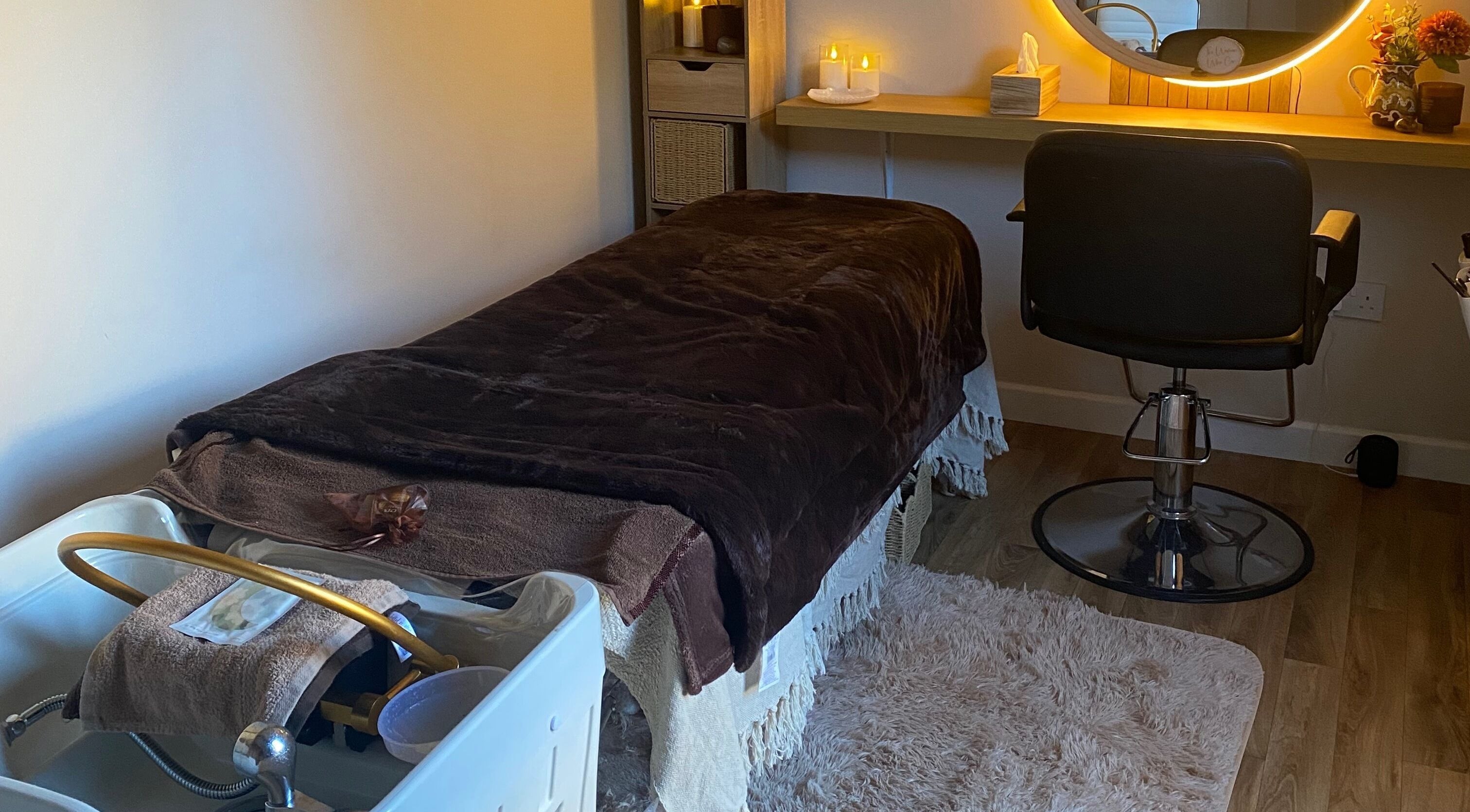Cozy spa room at The Healing Head Spa, Leighton Buzzard, England, GB with massage bed and chair.