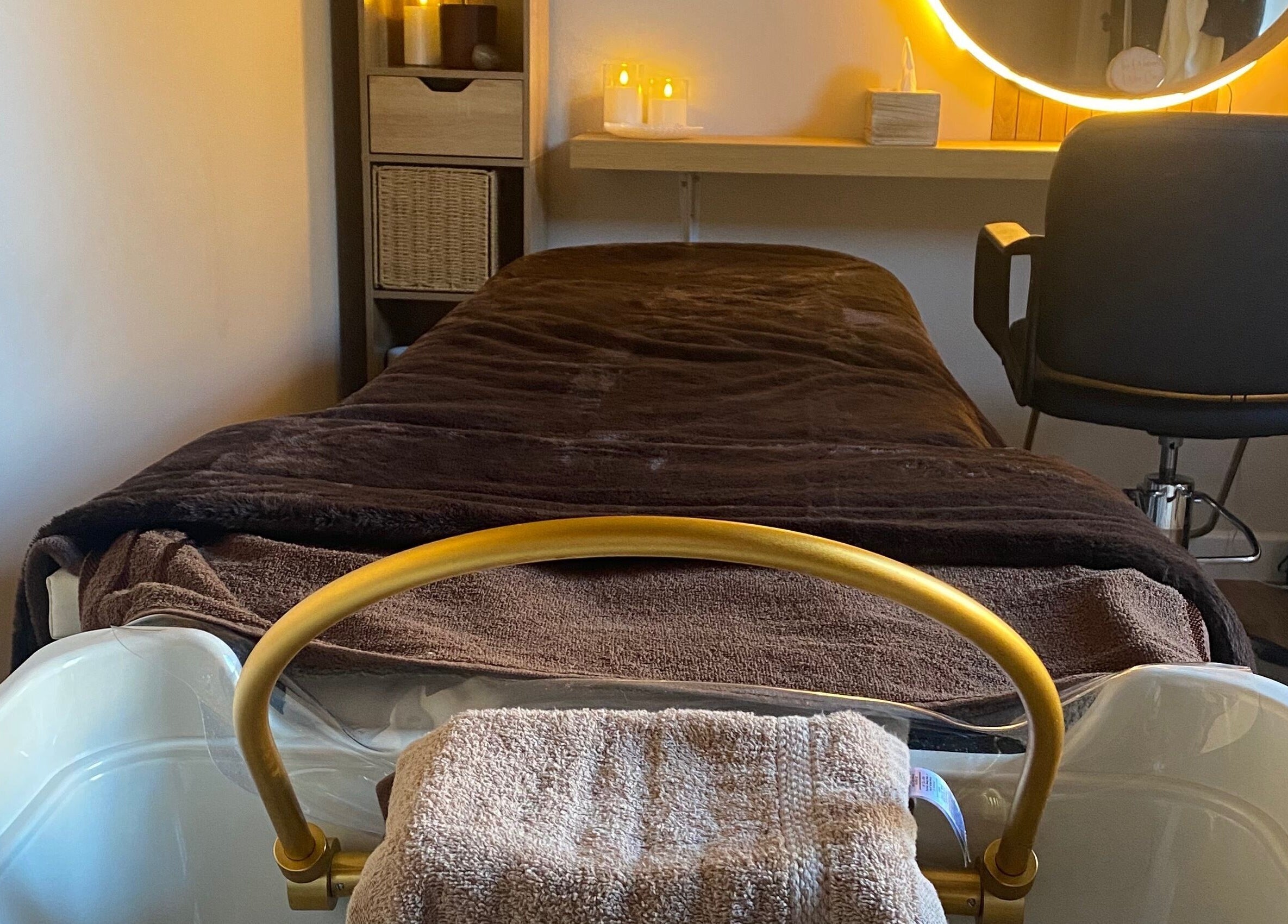 Cozy spa treatment room at The Healing Head Spa, Leighton Buzzard, England, GB, with softly lit decor.