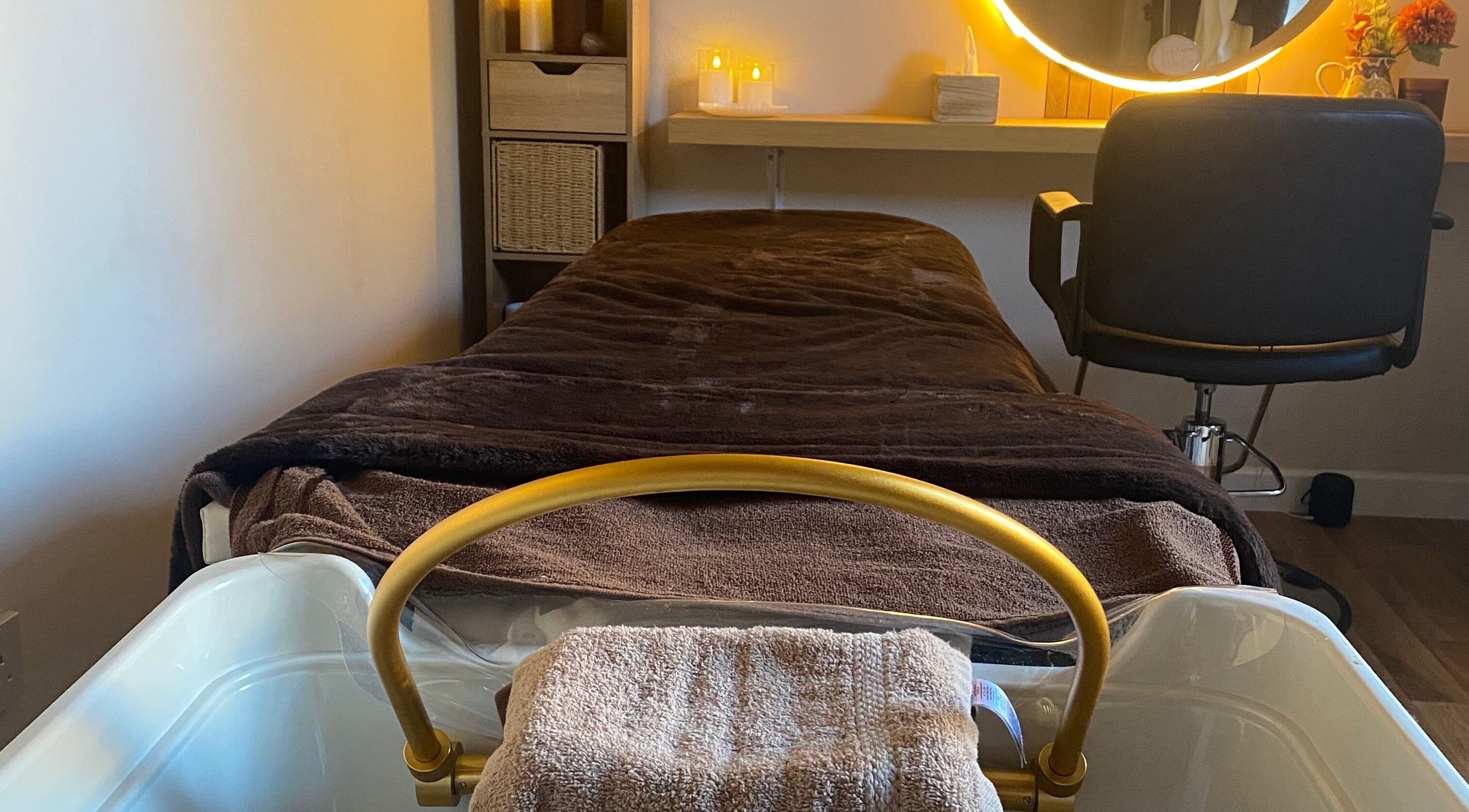 Cozy spa treatment room at The Healing Head Spa, Leighton Buzzard, England, GB, with softly lit decor.