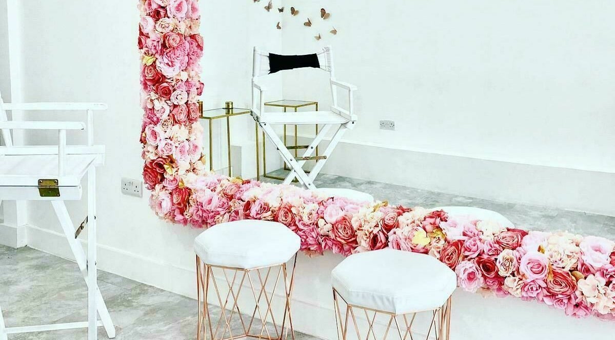 Elegant floral decor with white chairs at Nuova Beauty Bar, London, England, GB. Perfect for relaxation.