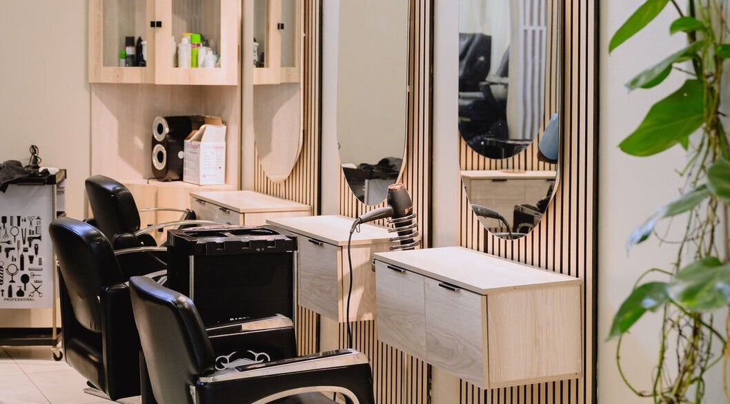 Modern salon interior at Enrich By Naseema, Lusaka, Lusaka Province, ZM with stylish chairs and mirrors.