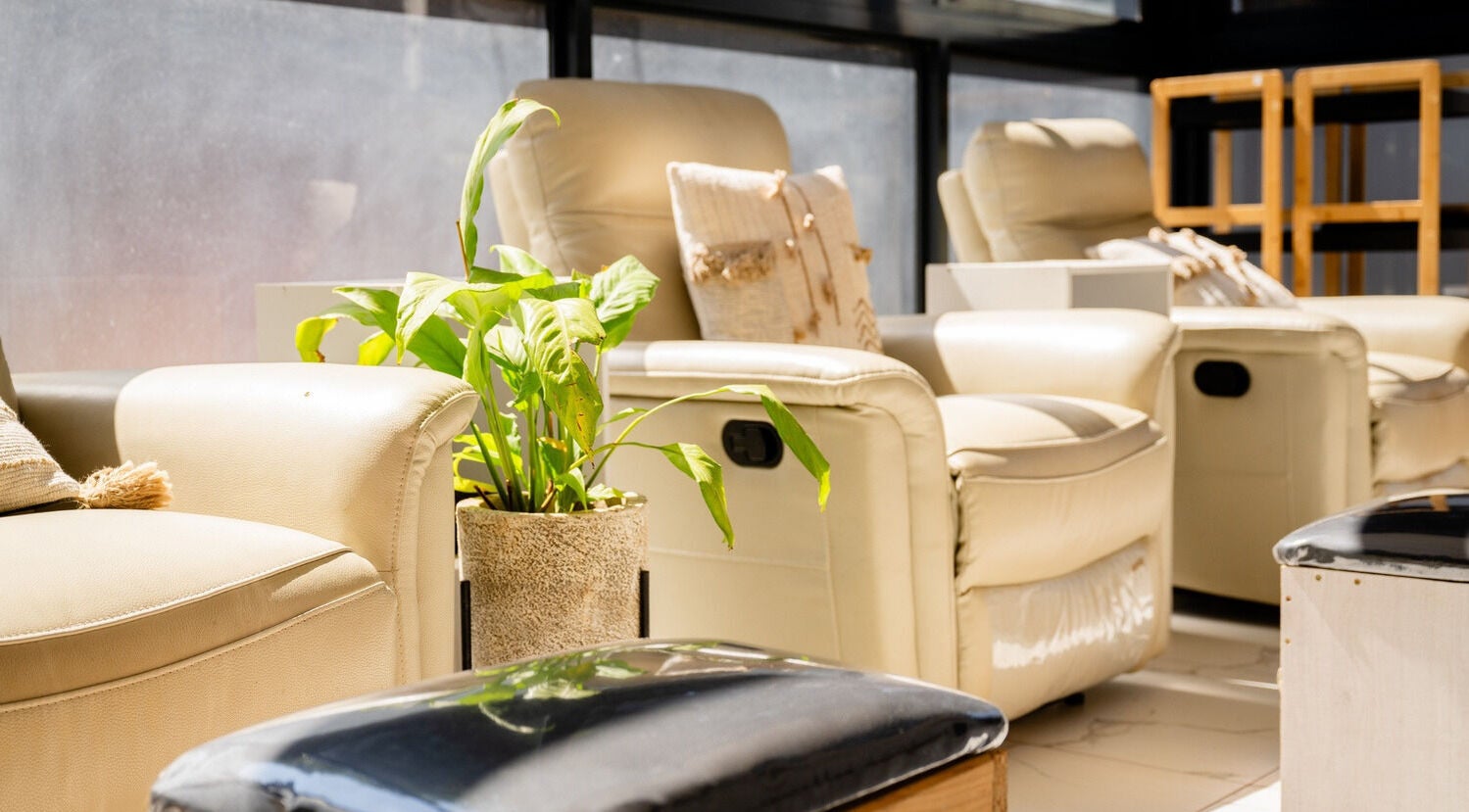 Relaxing chairs at Enrich Grooming Lounge 4 Men in Lusaka, Lusaka Province, ZM with a vibrant plant decor.