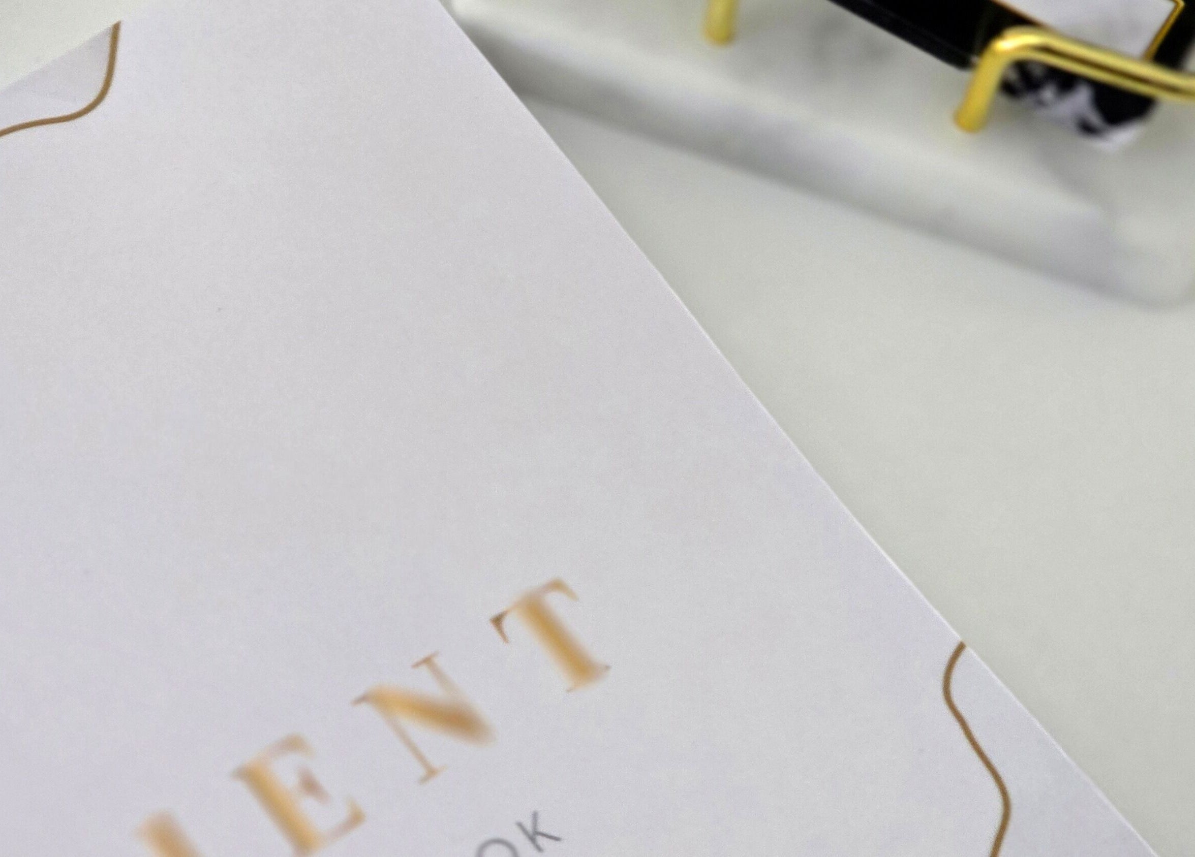 Close-up of appointment book at Amy's Nailed It, Neyland, Wales, GB, with gold accents.