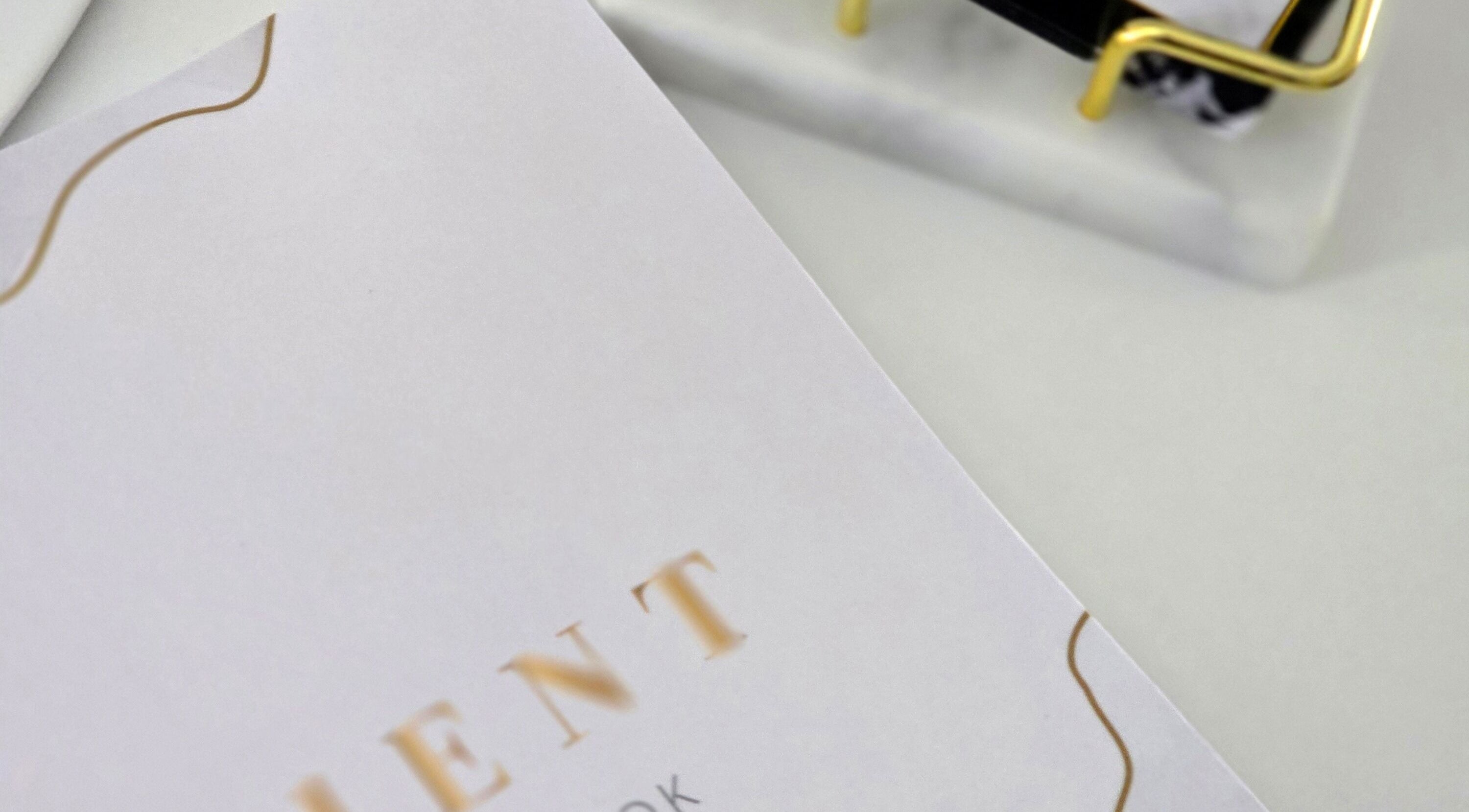 Close-up of appointment book at Amy's Nailed It, Neyland, Wales, GB, with gold accents.