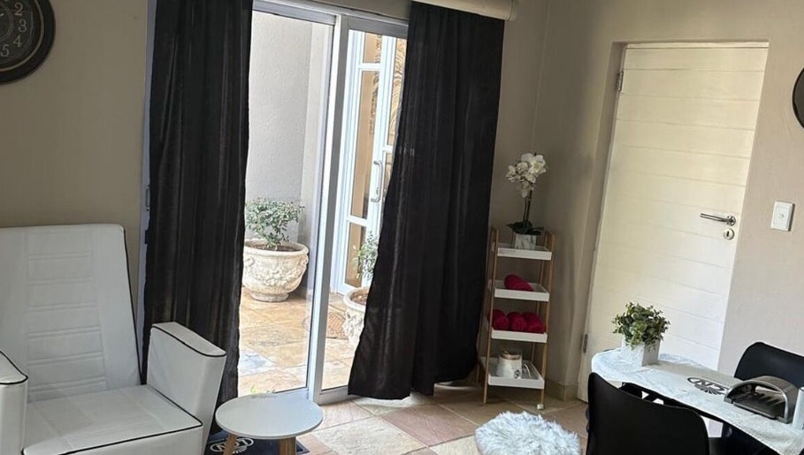 Cozy lounge at Touch Of Heaven Beauty Spa, Pretoria, Gauteng, ZA with white chair and natural light.