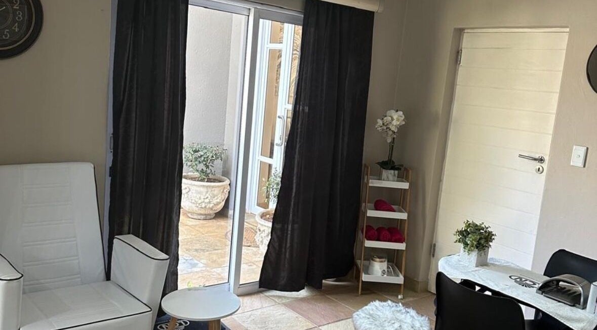 Cozy lounge at Touch Of Heaven Beauty Spa, Pretoria, Gauteng, ZA with white chair and natural light.