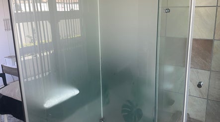 Luxurious shower area at Touch Of Heaven Beauty Spa in Pretoria, Gauteng, ZA, featuring elegant glass doors.