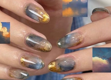 Elegant celestial-themed nail art at Palette Carys UK, London, England, GB, featuring clouds and gold accents.