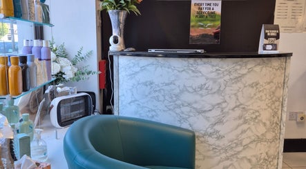 Stylish reception desk at Stephanie O'Keeffe Hair, Cork, County Cork, IE with products and decor.