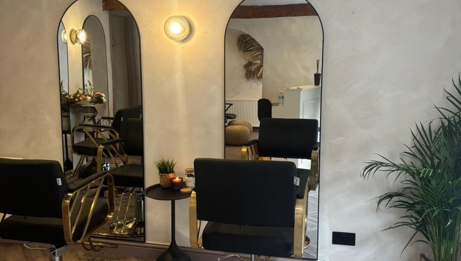 Stylish salon setup at Amica Hair & Beauty Thirsk, Thirsk, England, GB with modern mirrors and seating.
