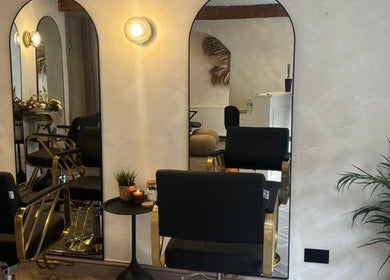 Stylish salon setup at Amica Hair & Beauty Thirsk, Thirsk, England, GB with modern mirrors and seating.