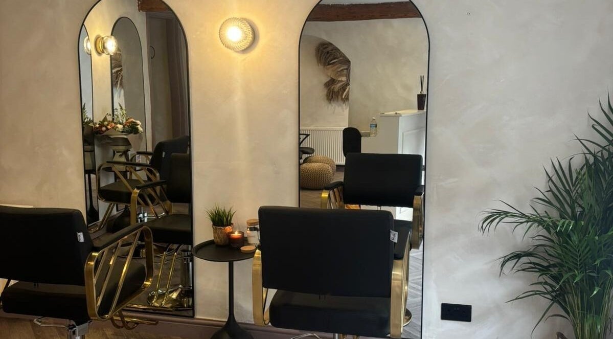 Stylish salon setup at Amica Hair & Beauty Thirsk, Thirsk, England, GB with modern mirrors and seating.