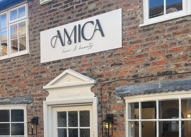 Amica Hair & Beauty Thirsk facade with elegant sign, Thirsk, England, GB.